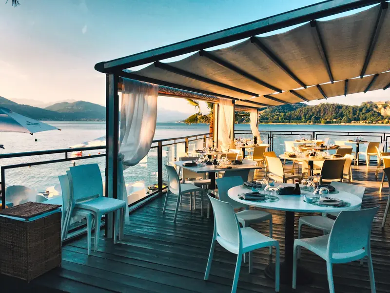 Restaurant terrace overlooking the water at dusk